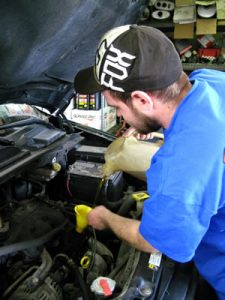 Checking engine fluids at Prime Auto Sales Omaha.