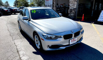 2015 BMW 320xi AWD silver sedan with aluminum alloy wheels and sunroof. Exterior view from front passenger corner.