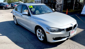 2014 BMW 320xi AWD silver sedan with aluminum alloy wheels and sunroof. Exterior view from front passenger corner.