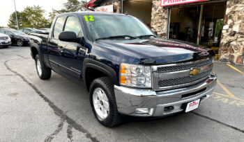 2012 Chevrolet Silverado 1500 LT extended cab 4X4 Imperial Blue Metallic with Aluminum/Alloy wheels, chrome accents, and bug deflector. Exterior view from the front passenger corner.